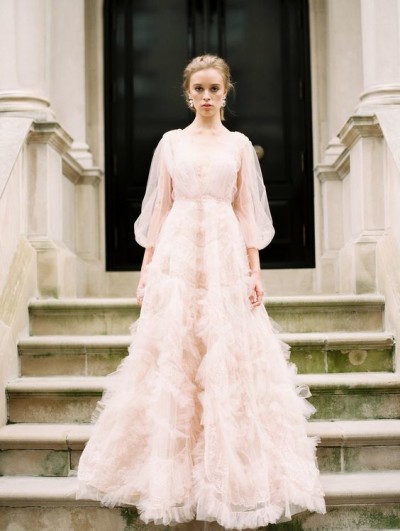 08-a-light-pink-wedding-dress-with-a-V-neckline-puff-tulle-sleeves-and-a-skirt-with-pink-tulle-appliques-for-a-chic-look